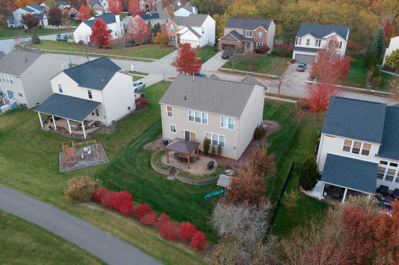 Wide elevated view of the back yard and patio with the walking path and surrounding homes