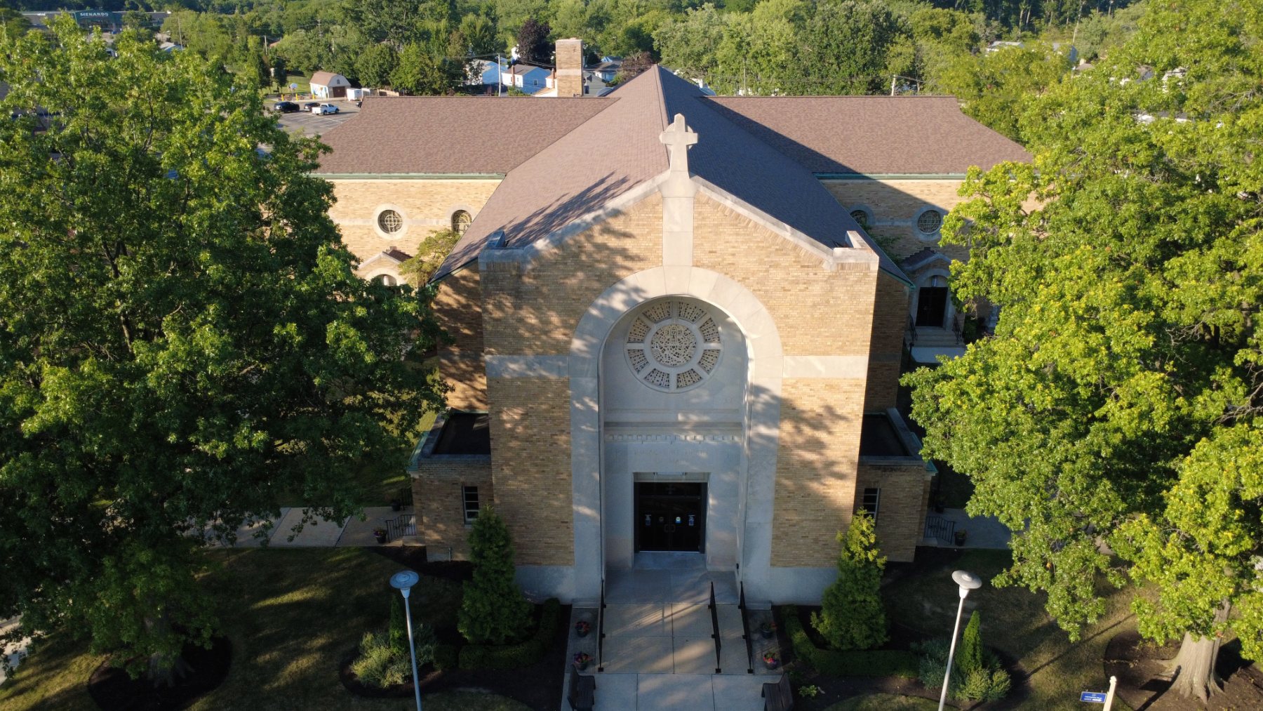 Aerial photograph of a brick church front, rose window and entry steps